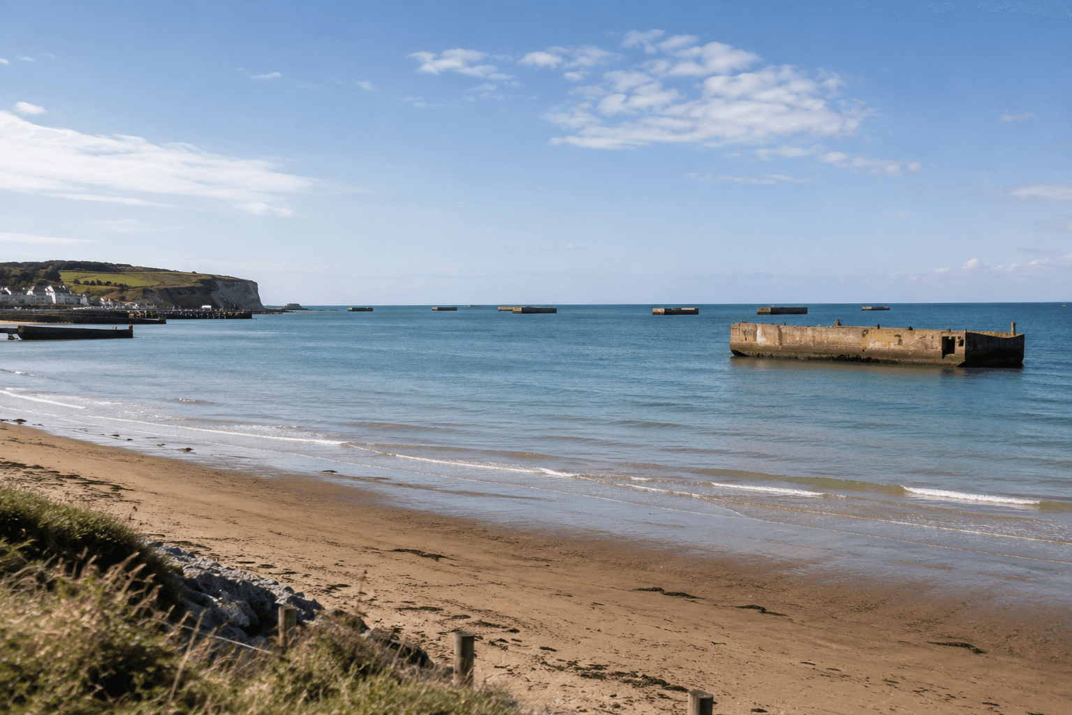 Arromanches beach with the remains of the Mulberry harbour — D-Day beaches 30 minutes from the Domaine de la Cour des Lys wedding venue